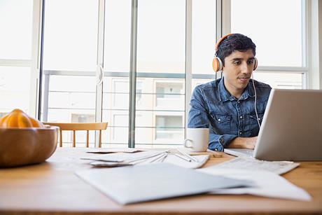 Photo of a person with a headset in front of a computer. If too complicated, photo of a headset or headphones to suggest the idea of listening.