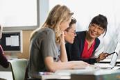 Photo of two people having a conversation, one should look like a teacher.