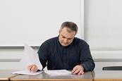 Photo of a teacher marking papers.