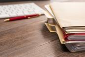 Photo of a person sorting out files, to suggest the idea of a portfolio. If too hard, photo of folders and files, in a pile for example.