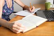 Photo of someone working on different versions of the same text, to show the different stages of the writing process.