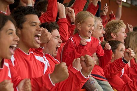 Photo of a father and son at a a football match, ideally Manchester fans.