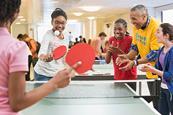 Photo of a teacher and their students playing a game in the classroom.