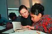 Photo of students using a dictionary or simply a photo of a dictionary.