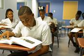 Photo of a student/s in a classroom reading.