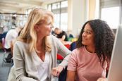 Photo of a teacher speaking to their students.