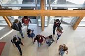 Photo of a school or of a classroom with students and their teacher.