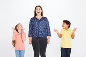 Phot of children in a classroom singing.