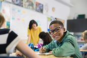 Photo of children writing in the classroom.