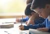 Ideally, photo of a child/ children using a dictionary. If too hard, photo of children in a classroom interacting with their teacher.