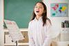 Photo of children sinnging,   ideally in a classroom.