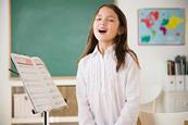 Photo of children sinnging,   ideally in a classroom.