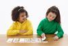 Photo of children playing a   card game.