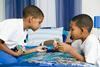 Photo of children playing a board game.