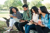 Photo of a student or group of students using  their mobile phones.