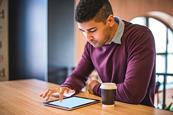 Photo of a teacher reading an article or a book.