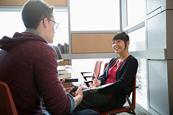 Photo of a teacher talking one to one with a student.