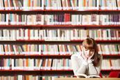 Photo of students reading in a classroom or in a library.