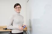 Photo of  a teacher in their classroom  or working at their desk.