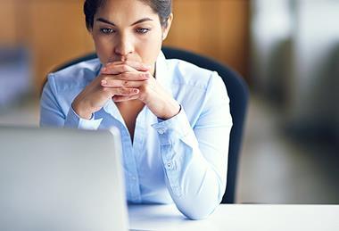 Photo of  a teacher in their classroom  or working at their desk.