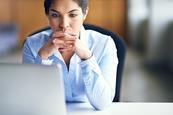 Photo of  a teacher in their classroom  or working at their desk.