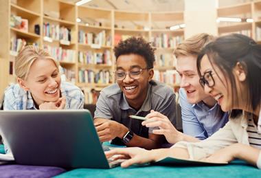 Teenage students looking at computer.