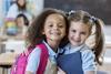 Two kindergarden girls smiling.