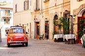 Car driving through streets in Italy