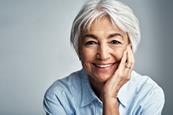 Elderly woman looking at camera, smiling