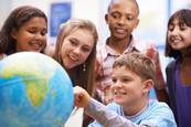 Kids gathered around a globe.