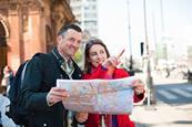 Couple of tourists looking at map